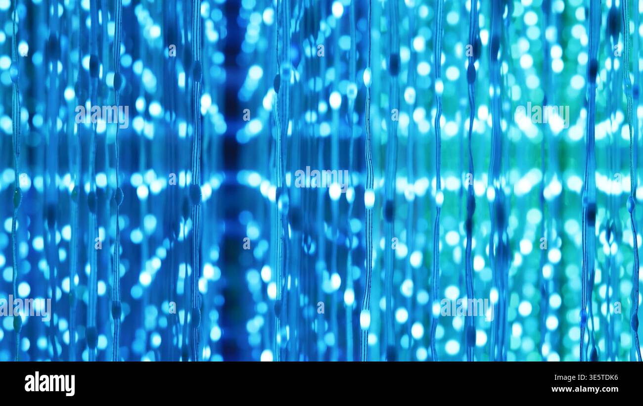 Glowing blue light dots creating abstract futurism and technology pattern bokeh Stock Photo