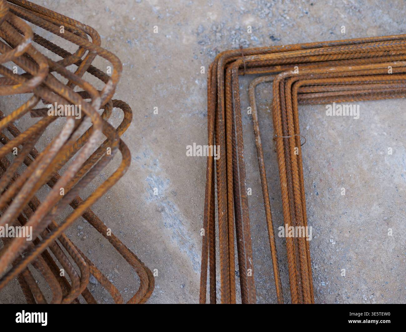 Rusty Rebar Rectangle bent rusty rebar rods on construction site, pile of L-shaped ribbed ...