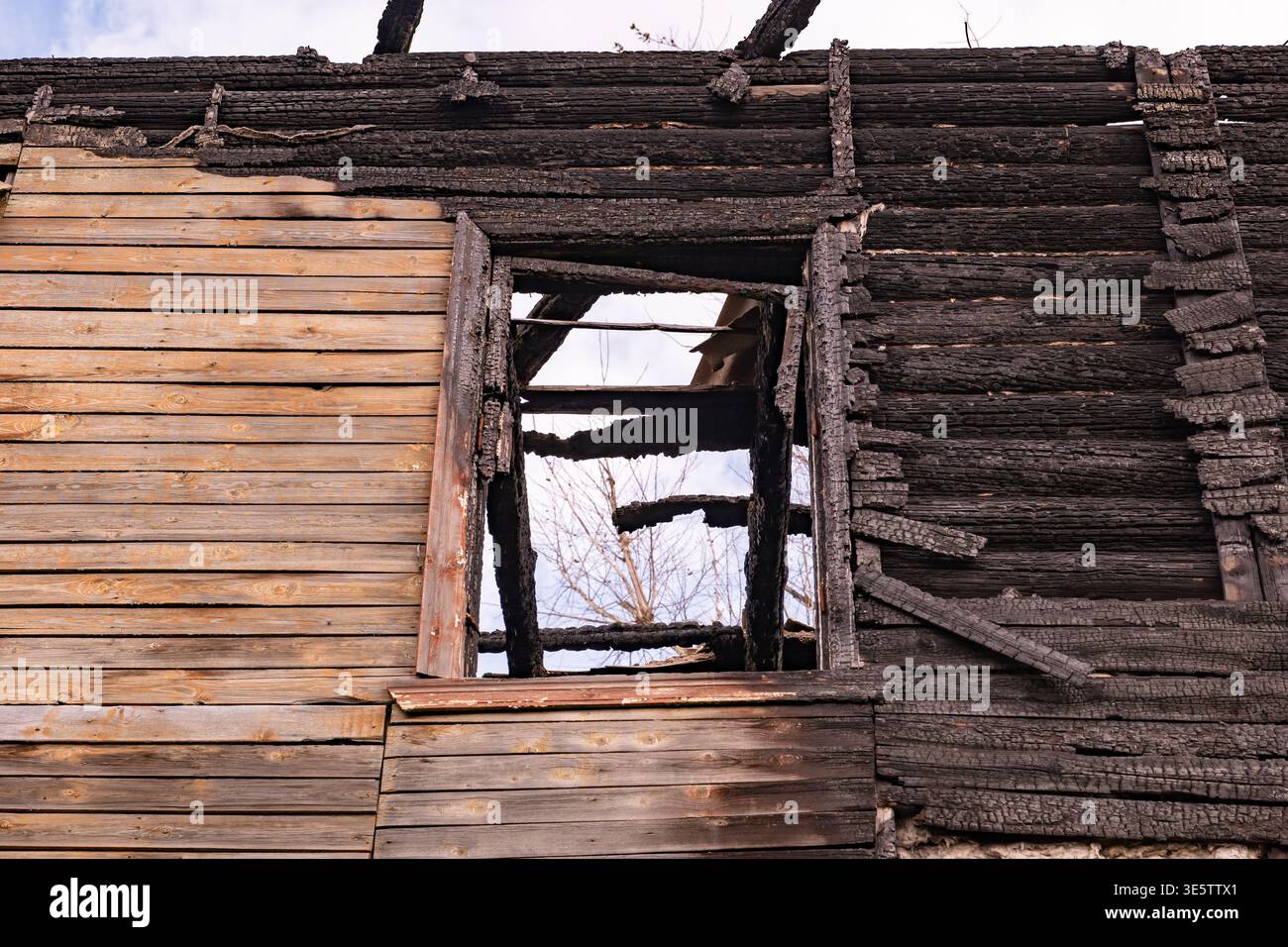 Burnt house structure showing extensive fire damage and destructive aftermath Stock Photo