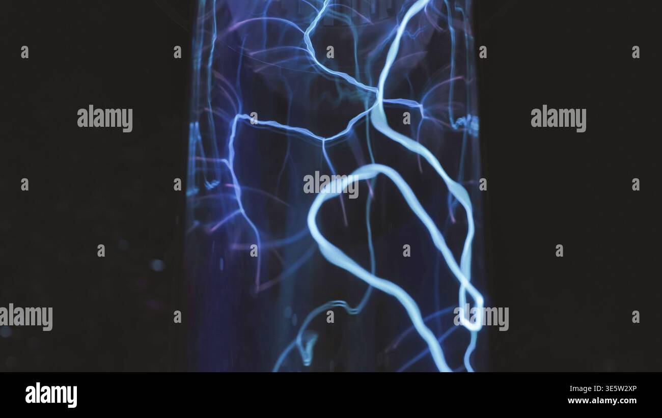 Blue electric plasma discharge creating light patterns in a science demonstration Stock Photo