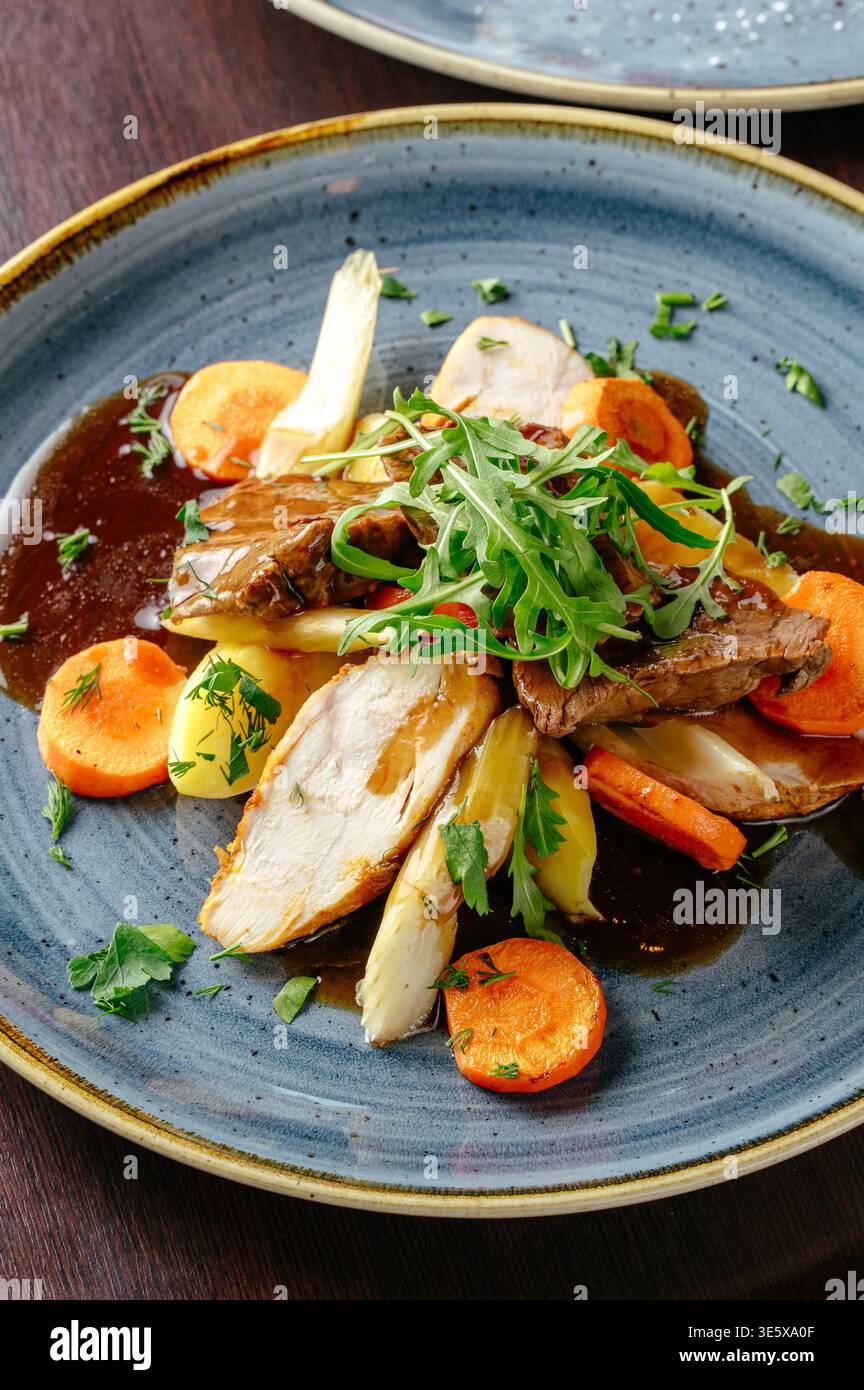stewed vegetables with meat and arugula Stock Photo