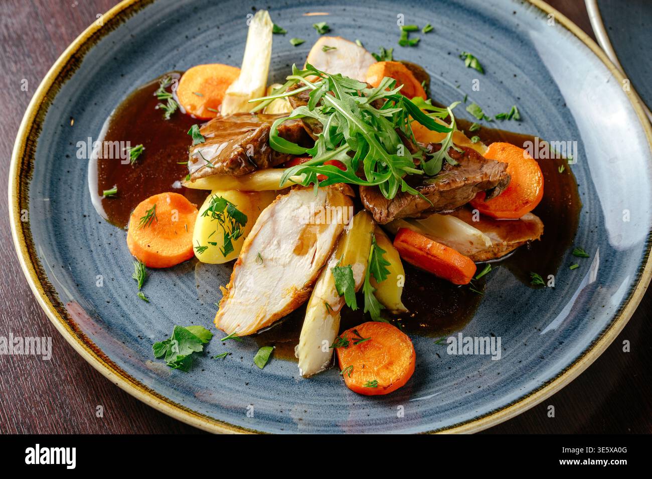 stewed vegetables with meat and arugula Stock Photo