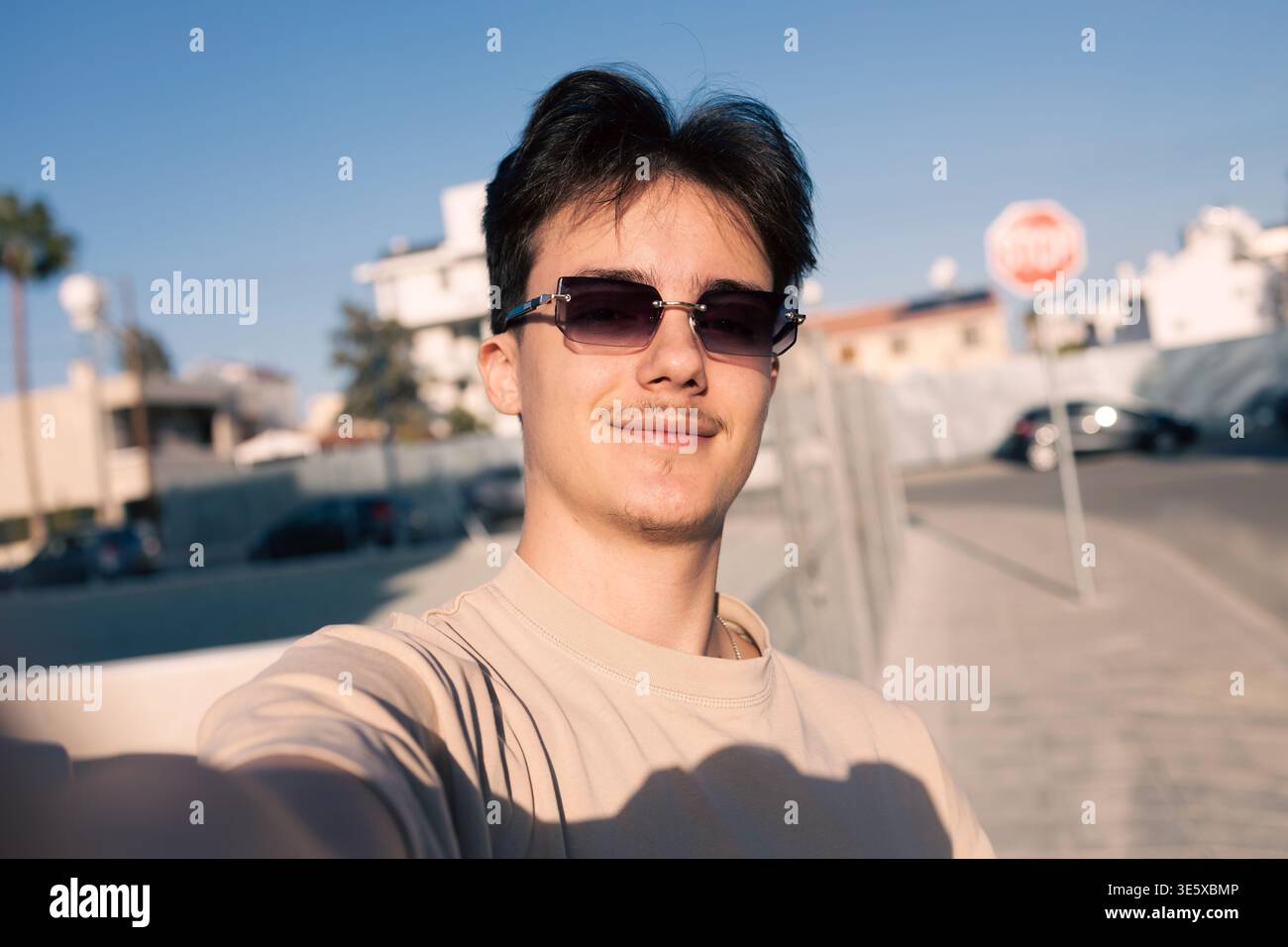 Confident young man taking selfie wearing sunglasses Stock Photo