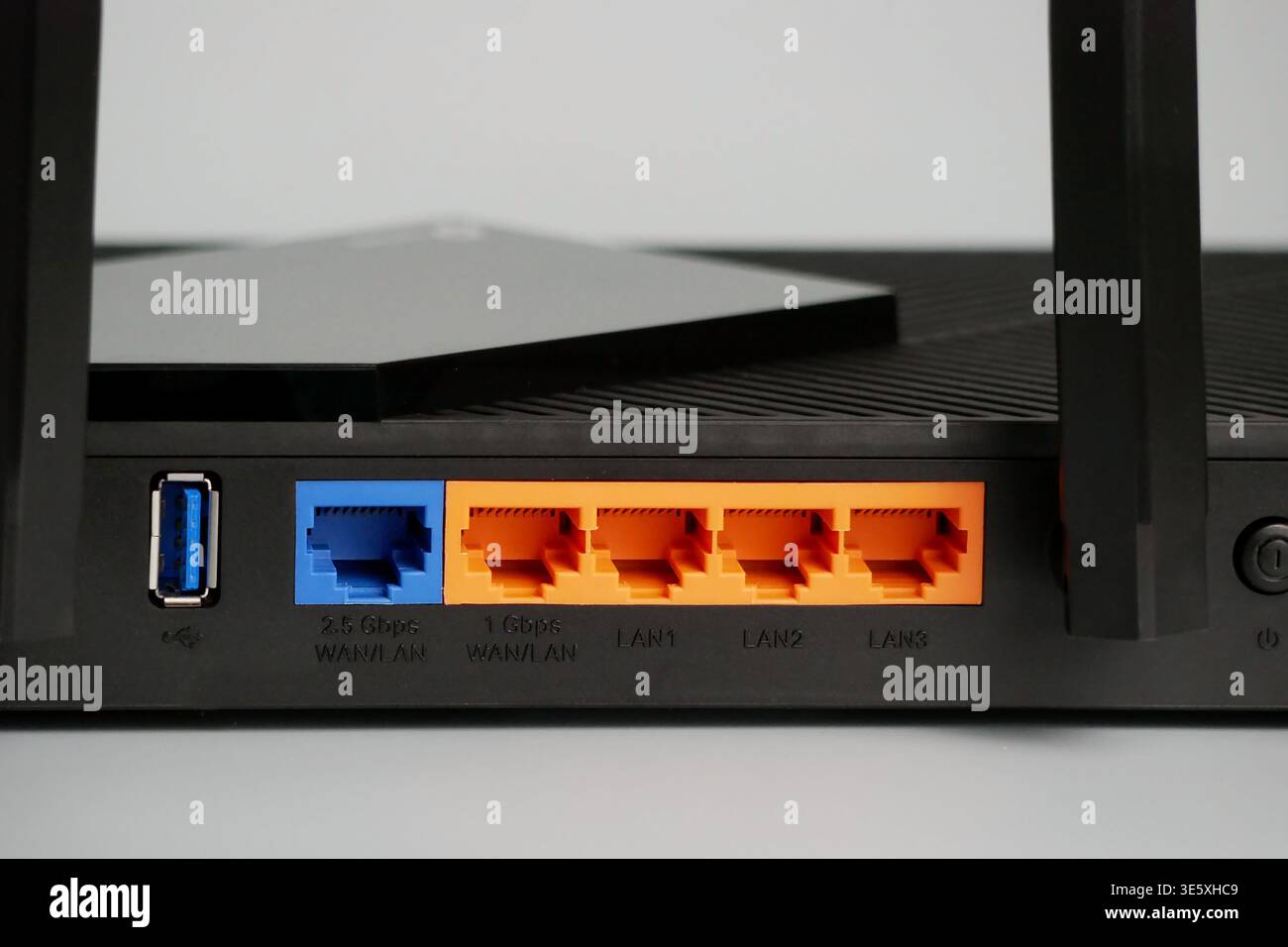Router Rear Photo Network router rear panel with orange gigabit ethernet ports, blue ...