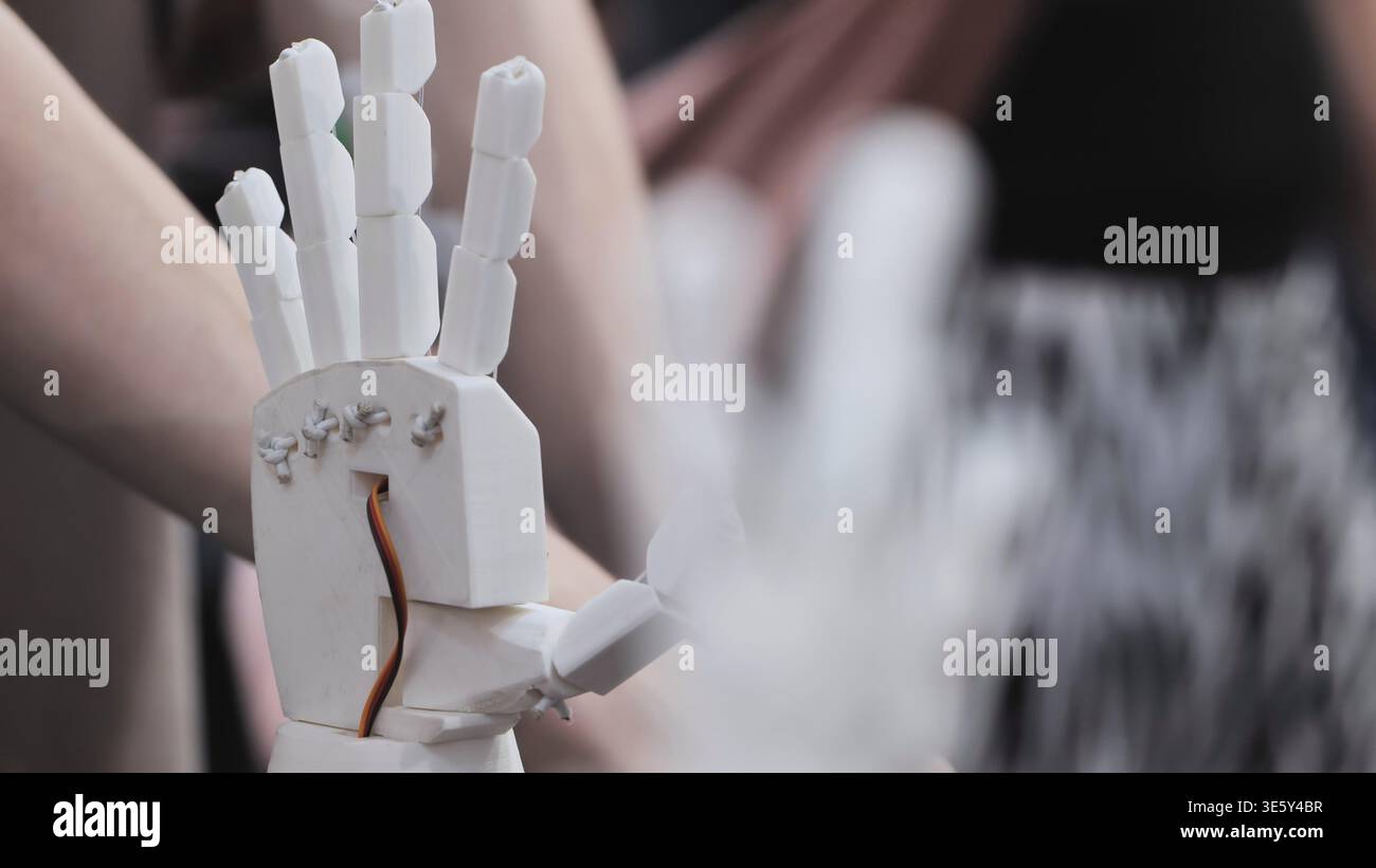 Robotic prosthetic hand prototype. Close up of a 3D printed bionic arm ...