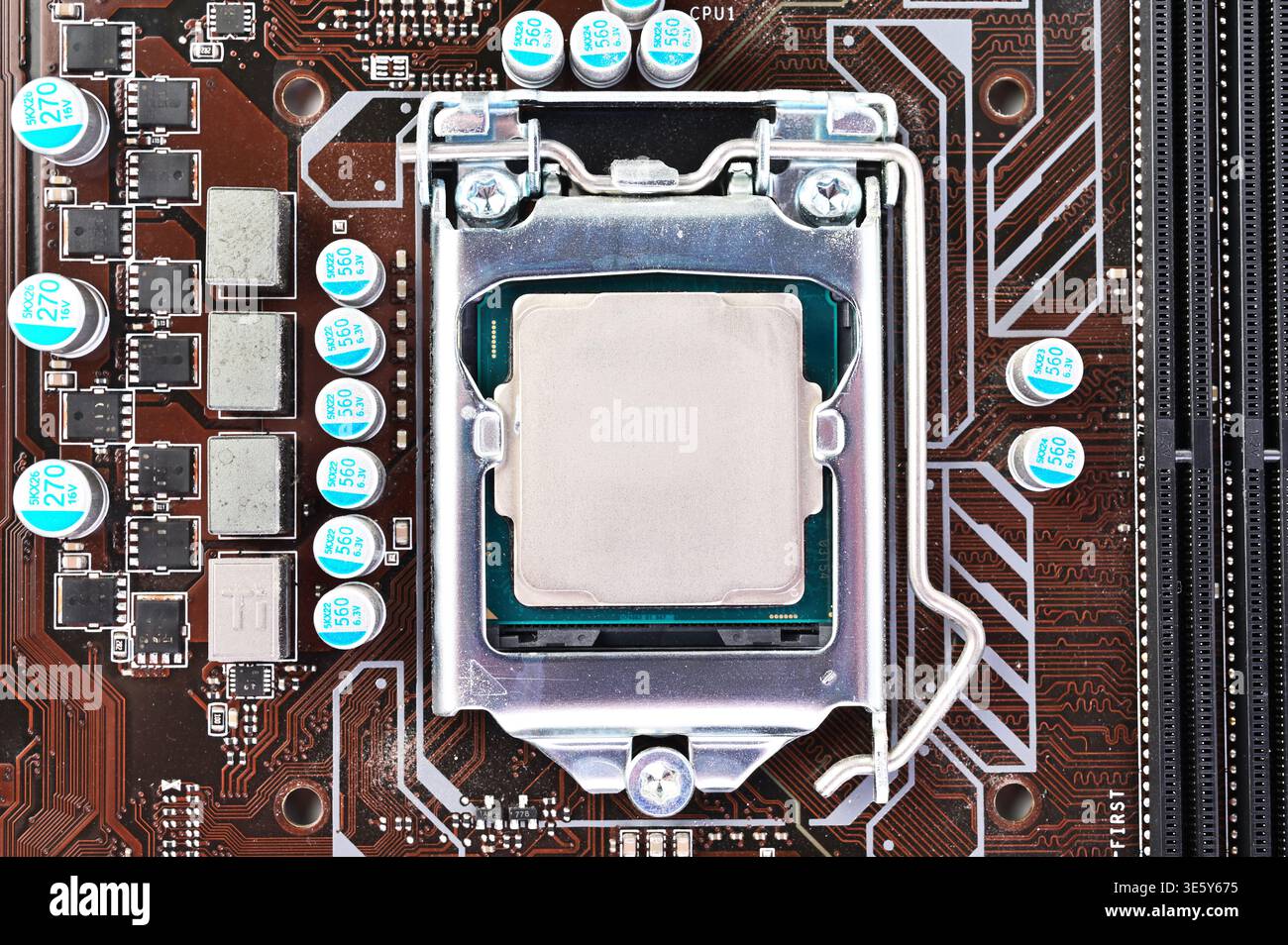 Close-up view of a computer motherboard with CPU socket and processor installed Stock Photo