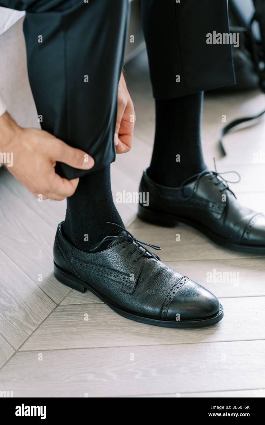 Thoughtfully Getting Ready For Special Event With Precise Motions And Focus Stock Photo