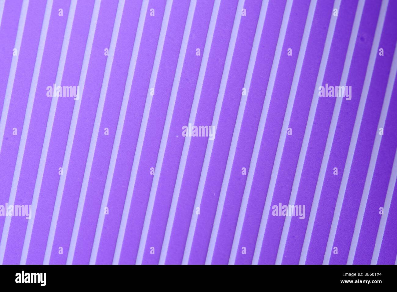 Abstract background featuring diagonal purple and white stripes with subtle digital screen texture and pixel effect Stock Photo