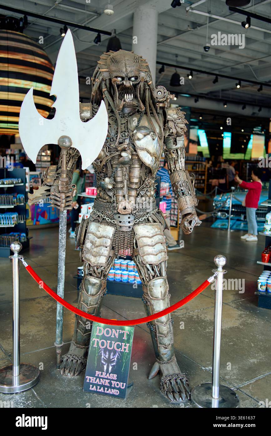Life-size Predator alien statue made of recycled metal parts in a Hollywood souvenir shop. Sci-fi movie character sculpture and retail interior. Stock Photo