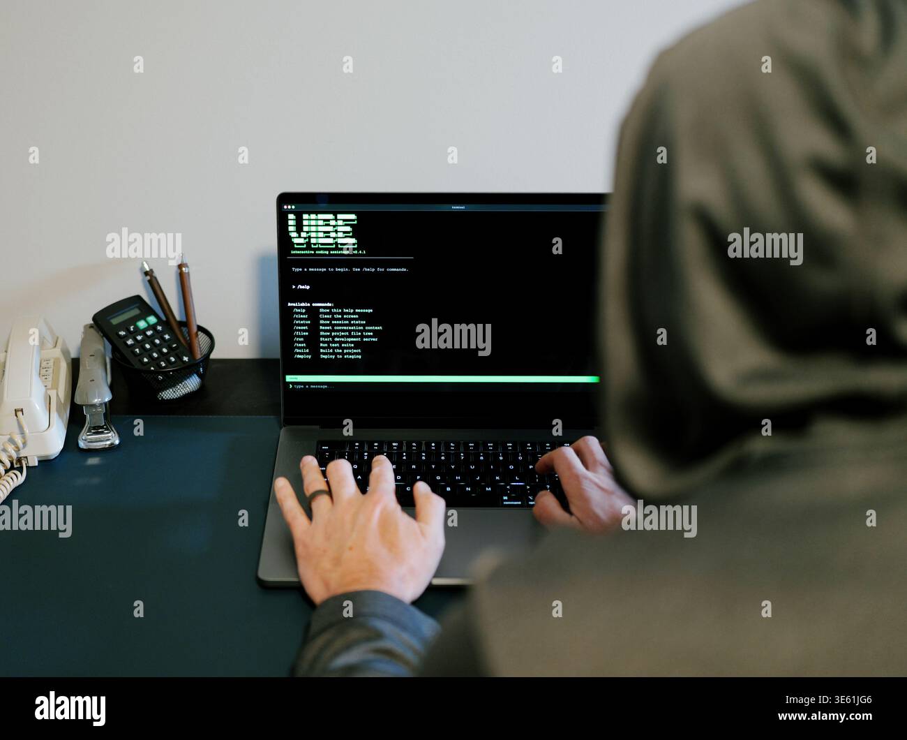 Middle Aged Man Turns Hacker in Hoodie After Using Vibe Coding Command Line Interface Artificial Intelligence Large Language Model Assistant Concept Stock Photo