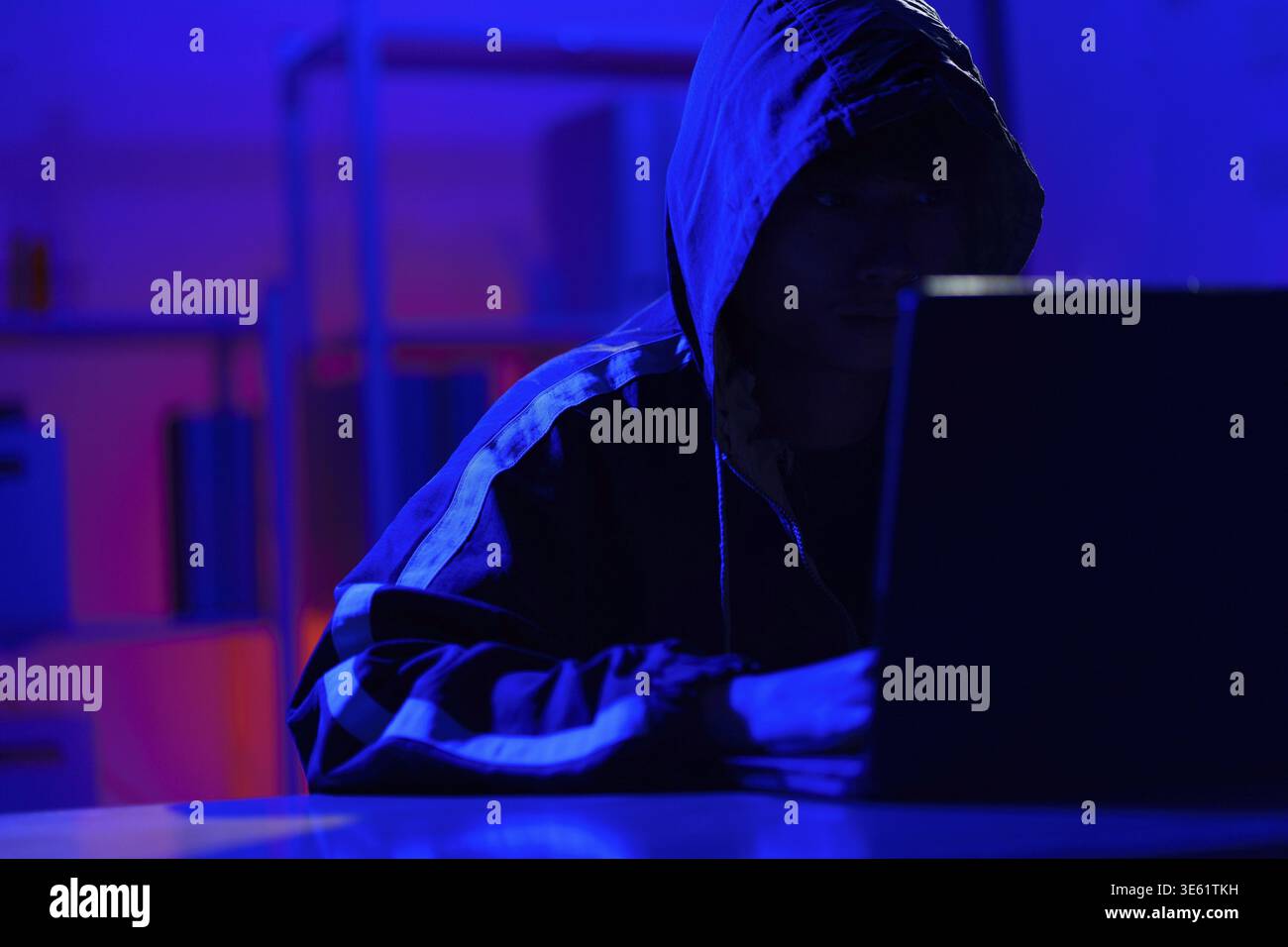 Hacker executing cyberattack representing data breach, system infiltration, and cybersecurity threat Stock Photo