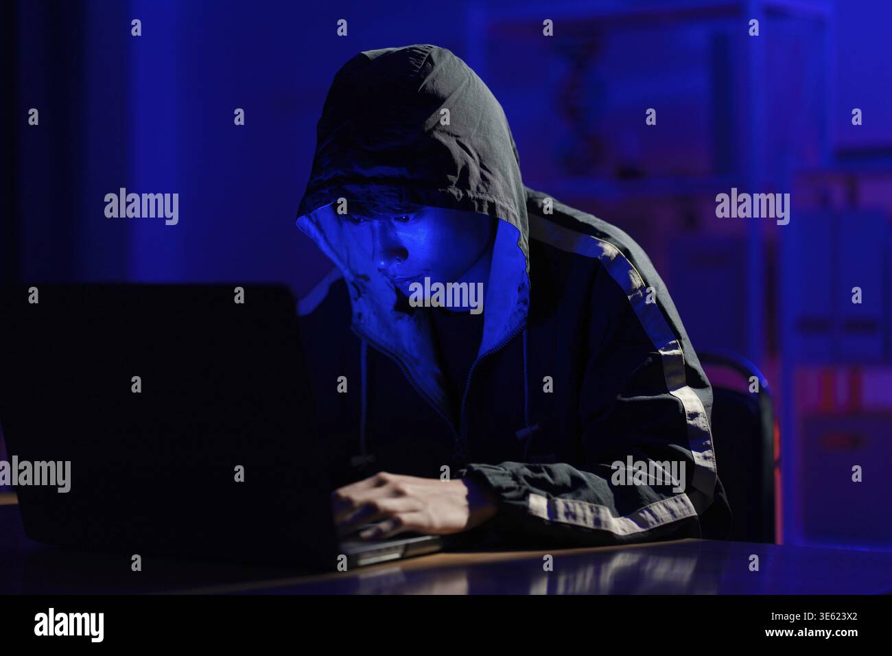 Hacker executing cyberattack representing data breach, system infiltration, and cybersecurity threat Stock Photo
