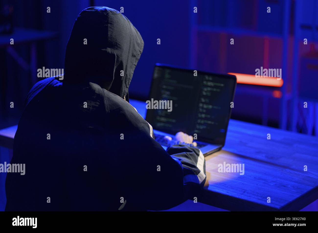 Hacker executing cyberattack representing data breach, system infiltration, and cybersecurity threat Stock Photo