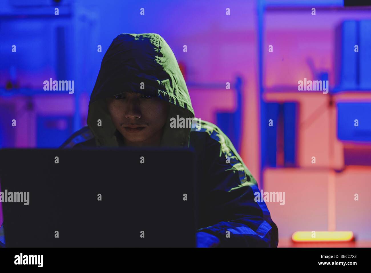 Hacker executing cyberattack representing data breach, system infiltration, and cybersecurity threat Stock Photo
