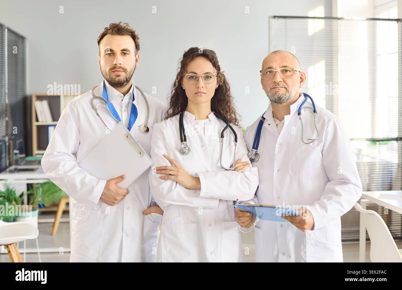 Confident medical team of doctors with stethoscopes in modern clinic office portrait Stock Photo