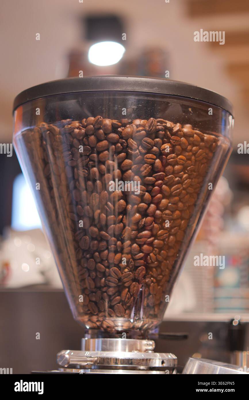 Coffee beans in grinder at cafe during day Stock Photo