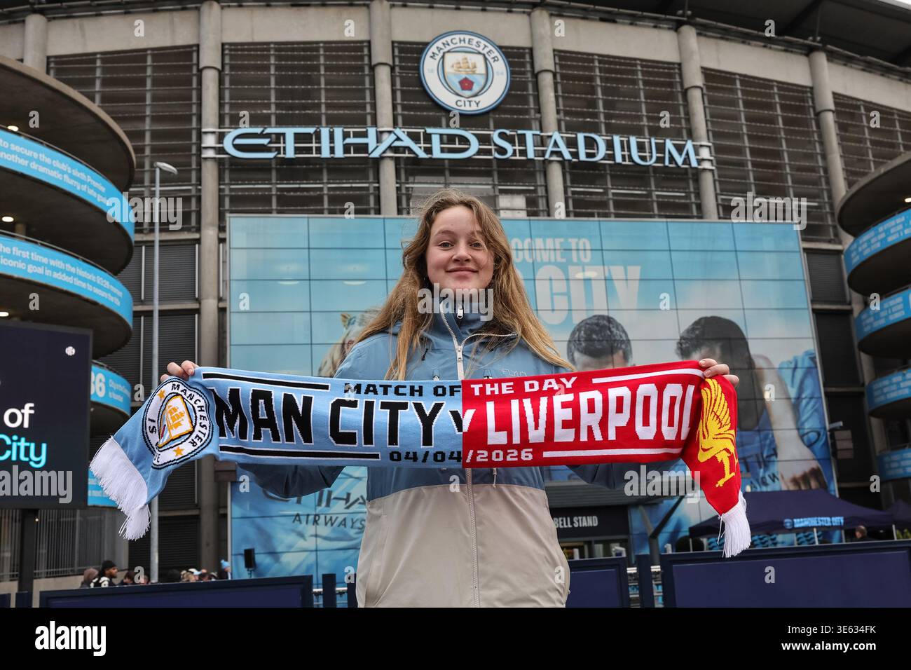 Manchester city fan holds up scarf in the hi-res stock photography