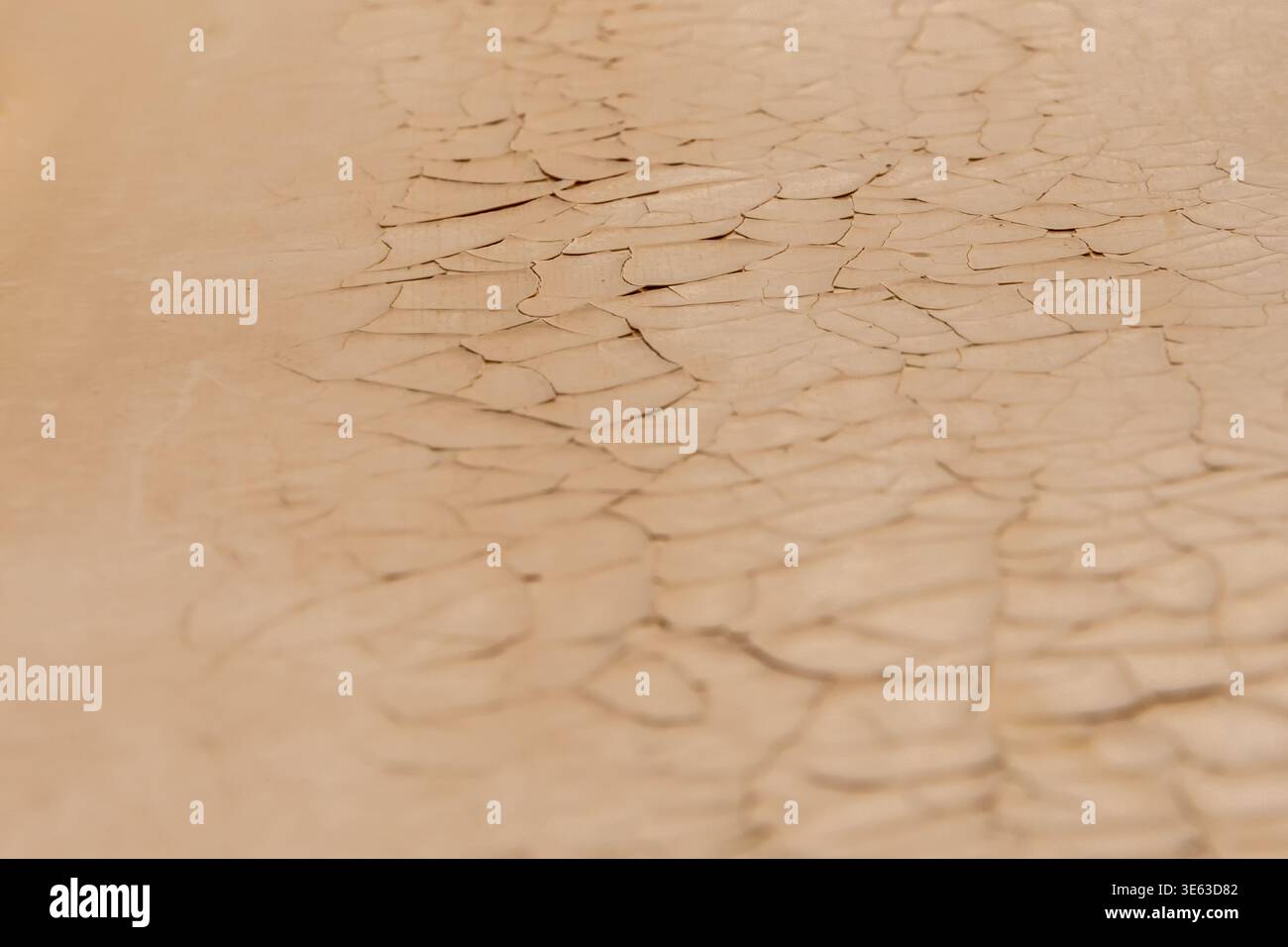 Peeling paint on wall forms detailed pattern of old coating material. Stock Photo
