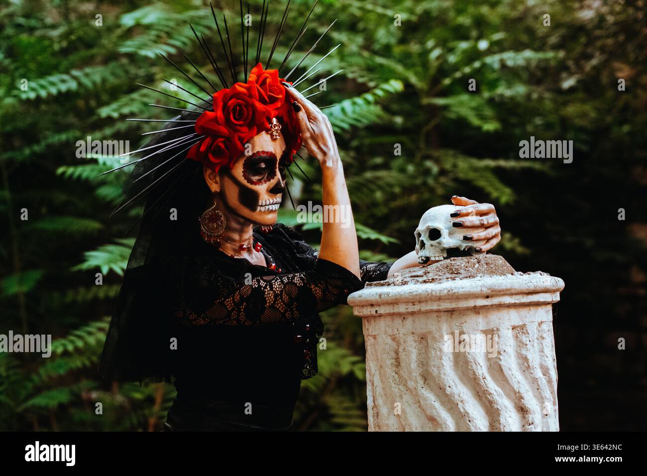 Day of the Dead. Portrait of a woman with a wreath of red roses and a skull on a column. Artistic composition Stock Photo