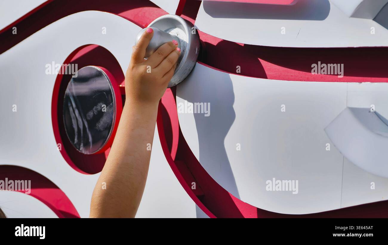 Hand Pressing Button on Interactive Sports Display Stock Photo