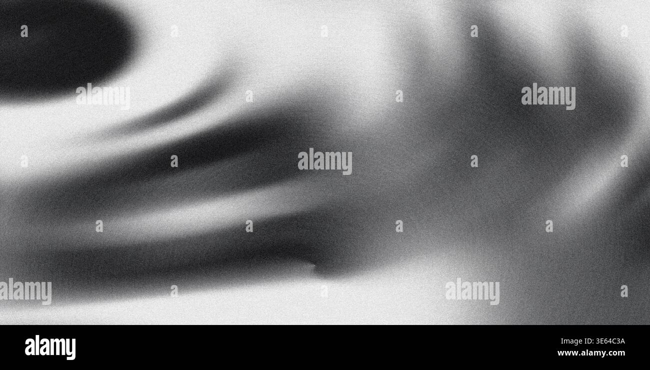 A black and white swirl design on a gray background with shadows creating a dramatic and contrasting visual composition with shades of black white and Stock Photo