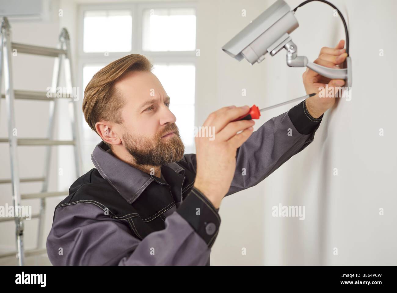 Serious Workers Installing Surveillance Camera Stock Photo