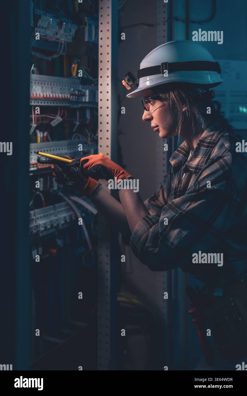 Technical specialist inspecting electrical system with voltage tester. Engineering control. Stock Photo