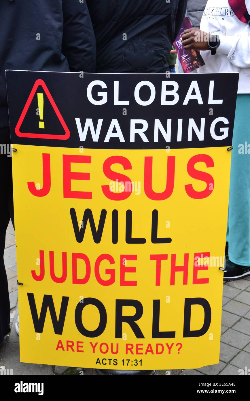 A Christian street evangelism sign reading “Global Warning – Jesus Will ...