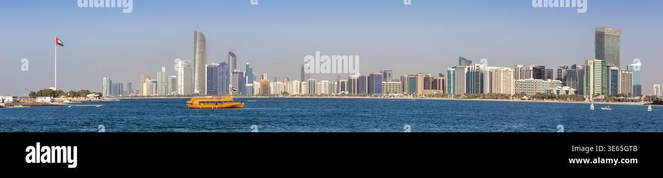 Abu Dhabi skyline with skyscrapers panorama and Dhow boat at sea traveling in Abu Dhabi, United Arab Emirates Stock Photo