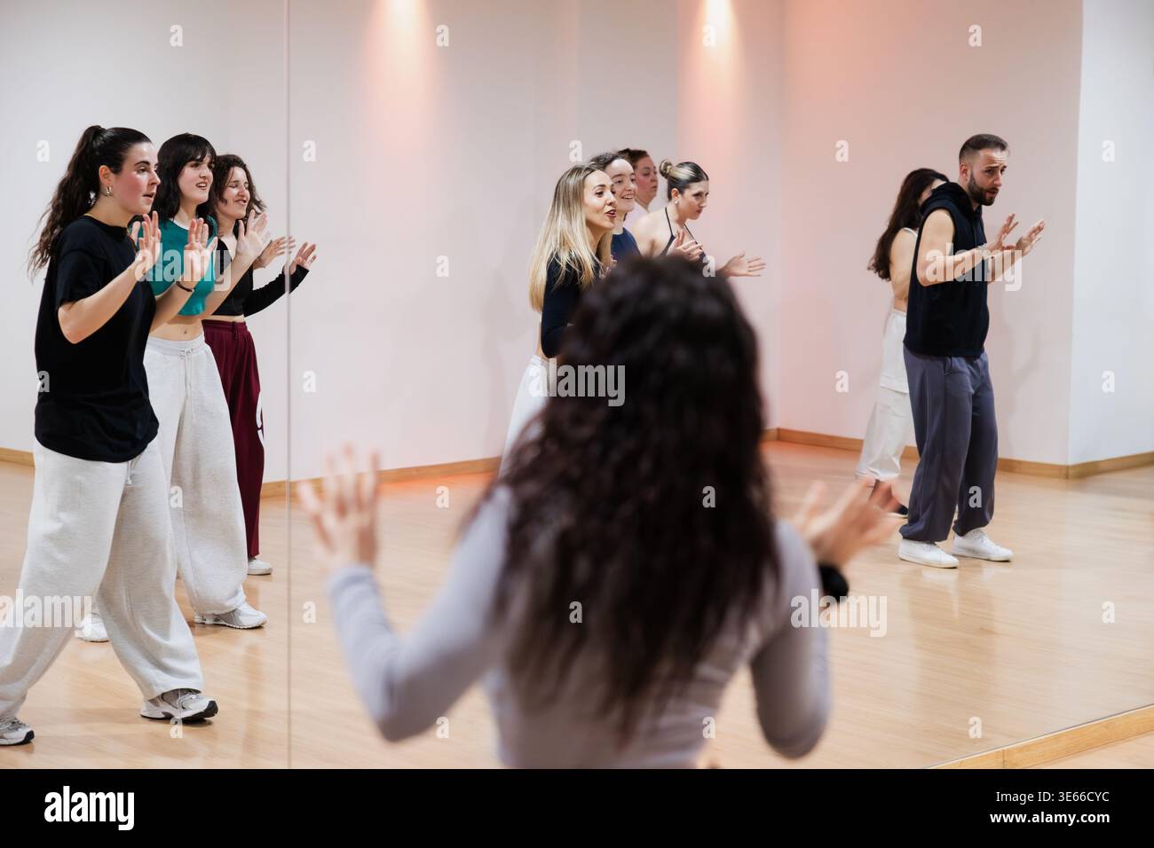 Dancers rehearsing choreography in mirror reflection studio Stock Photo