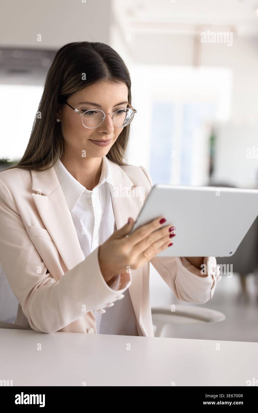Elegant woman using digital tablet at workplace Stock Photo