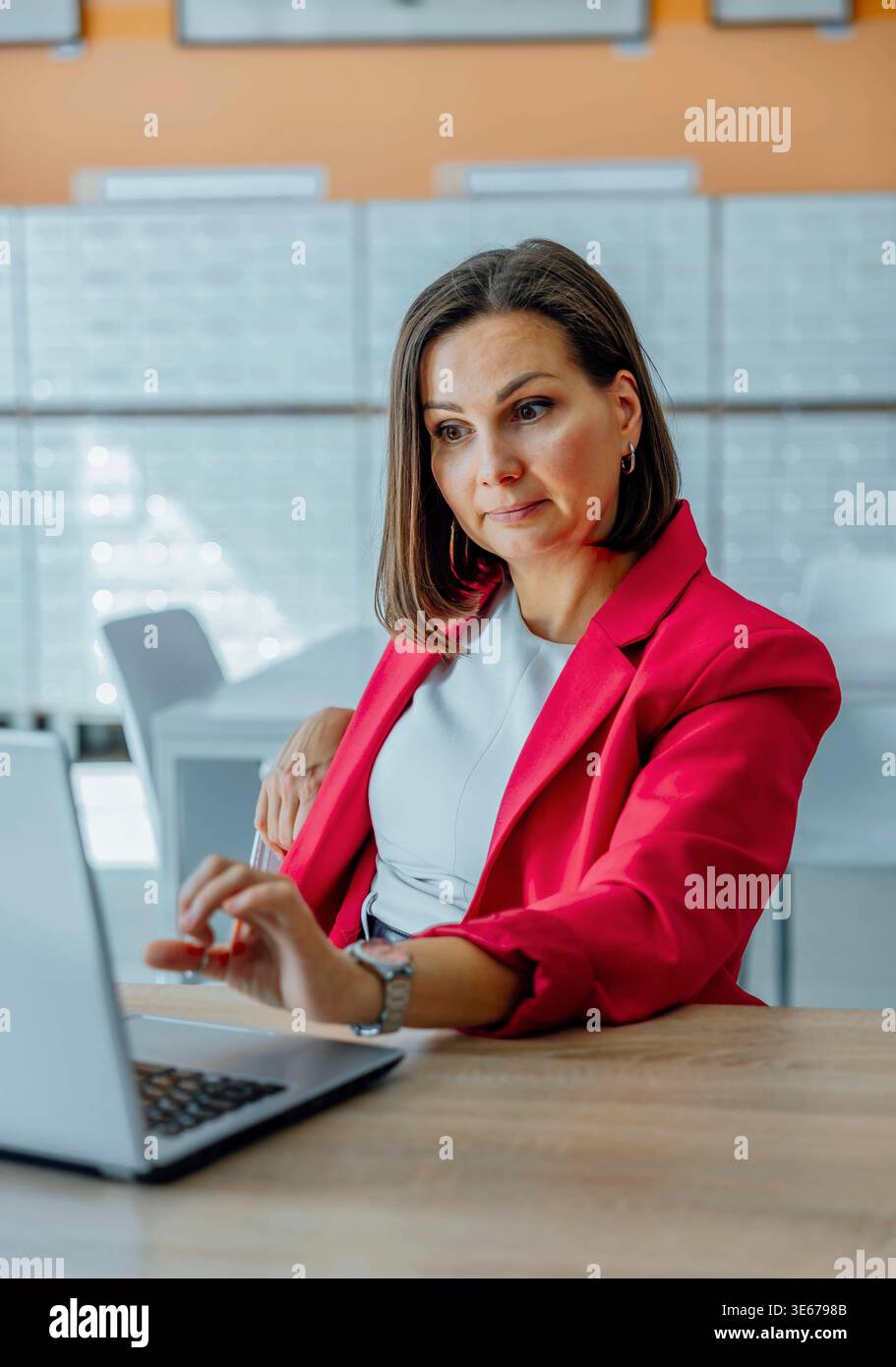 Surprised woman in red blazer hi-res stock photography and images - Alamy