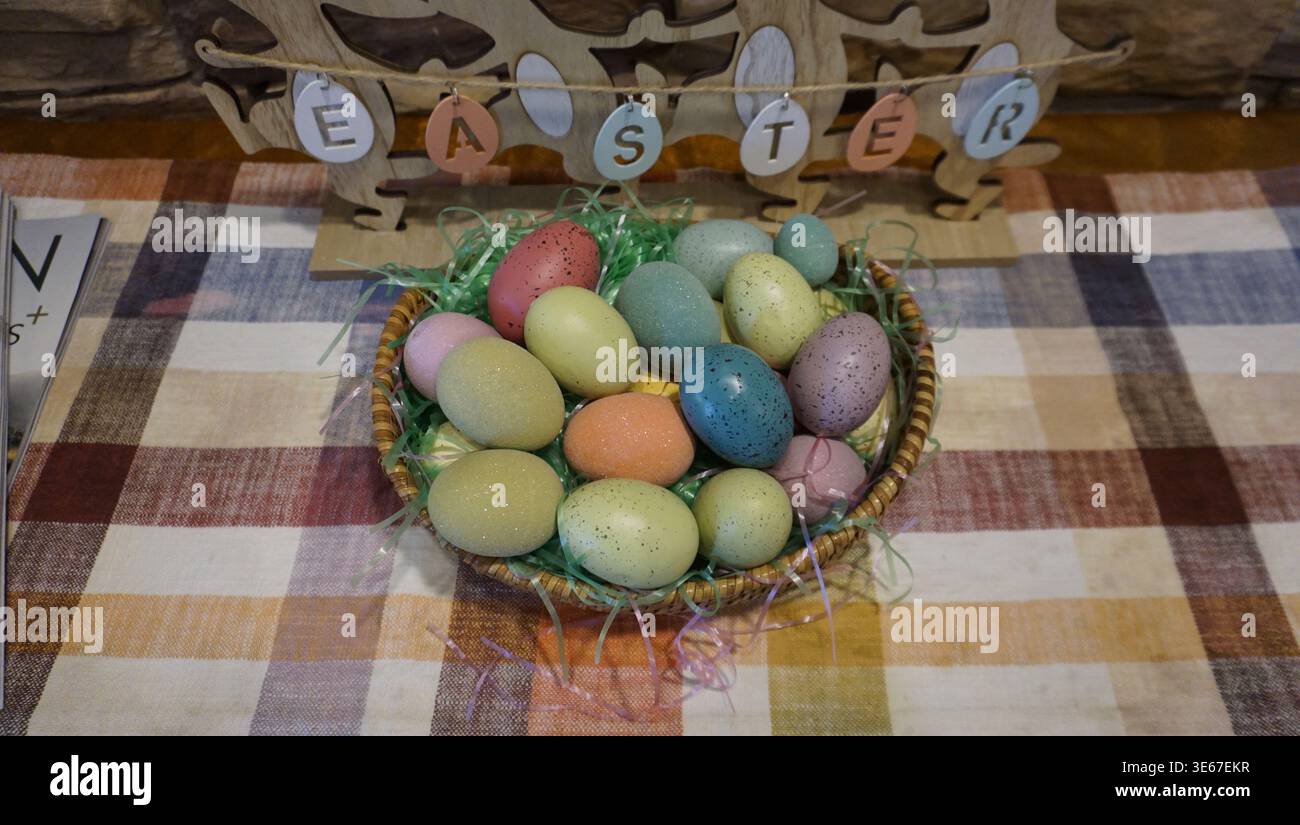 Easter Basket with Colorful Eggs and Spring Decorations Stock Photo