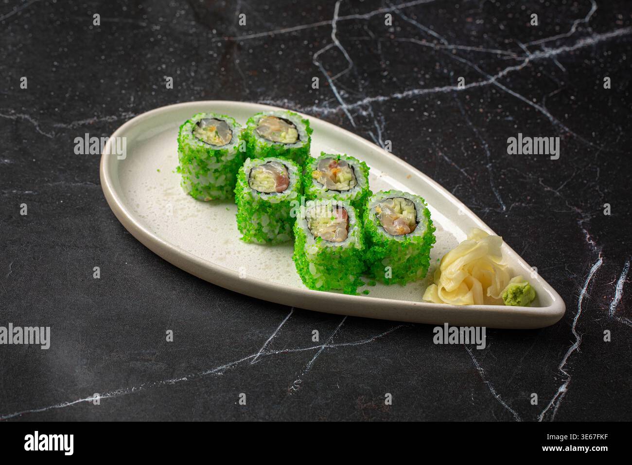 Sushi rolls with green coating and ginger Stock Photo