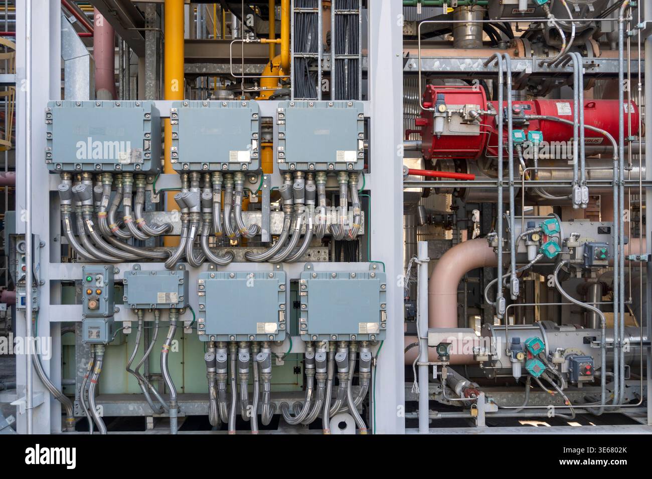 A detailed view of gray industrial junction boxes with extensive ...