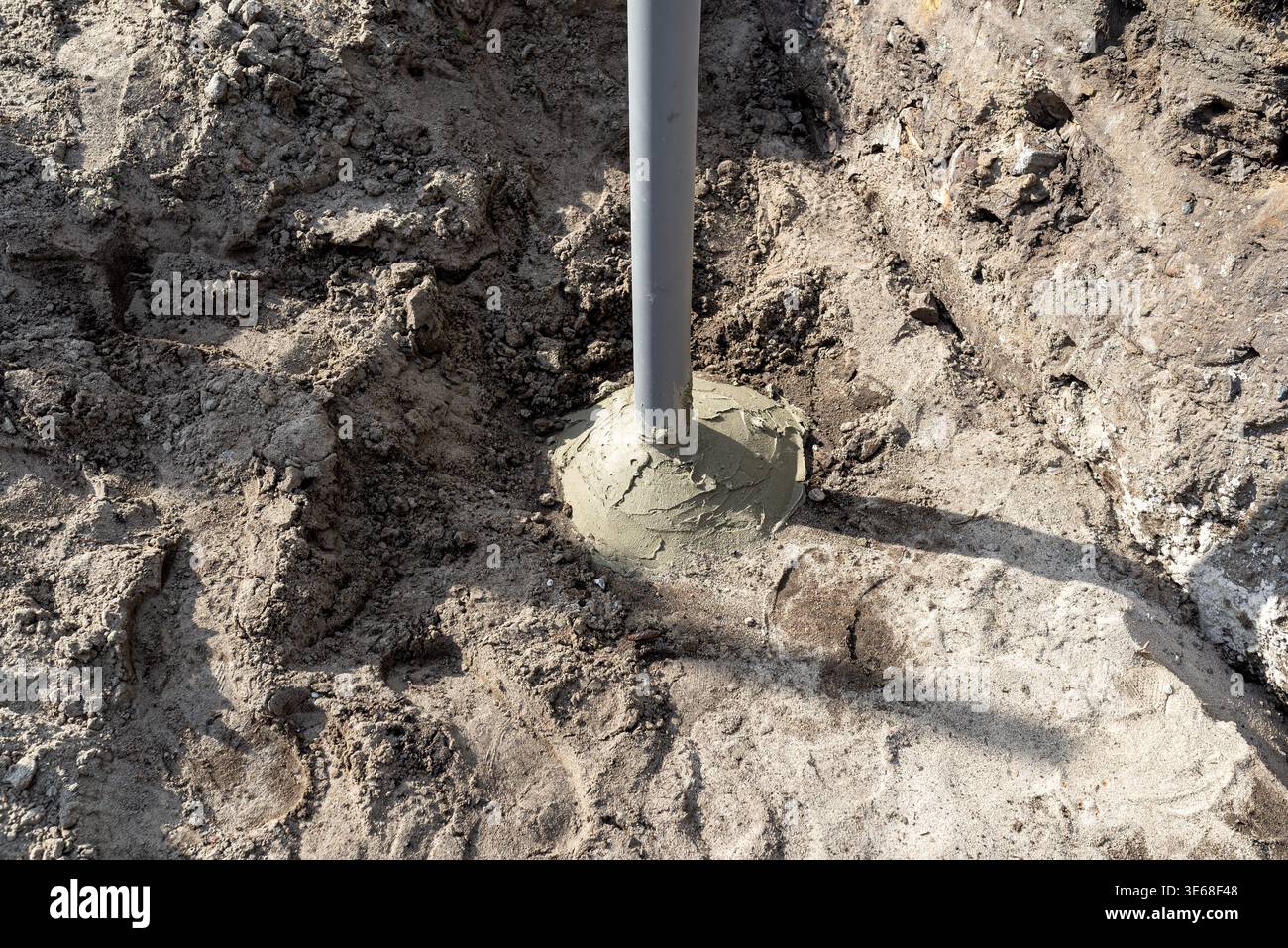 Pvc vent pipe rising from a cement base embedded in the soil Stock ...