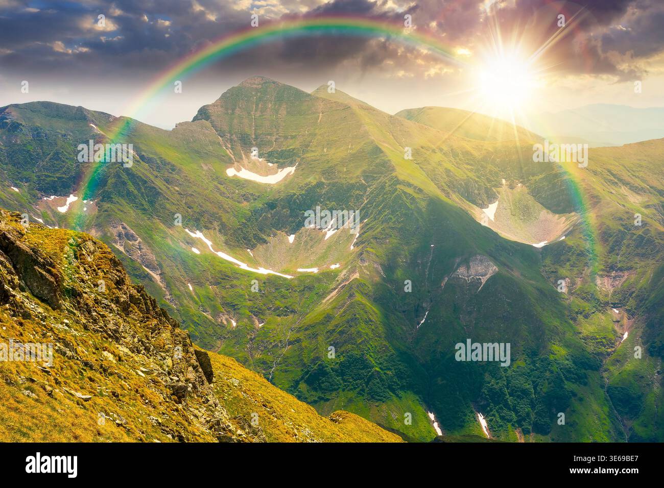 sunset over mountain scenery in summer. gorgeous mountainous landscape. background with rocky cliffs and grassy hillsides under a cloudy sky. ridge of Stock Photo