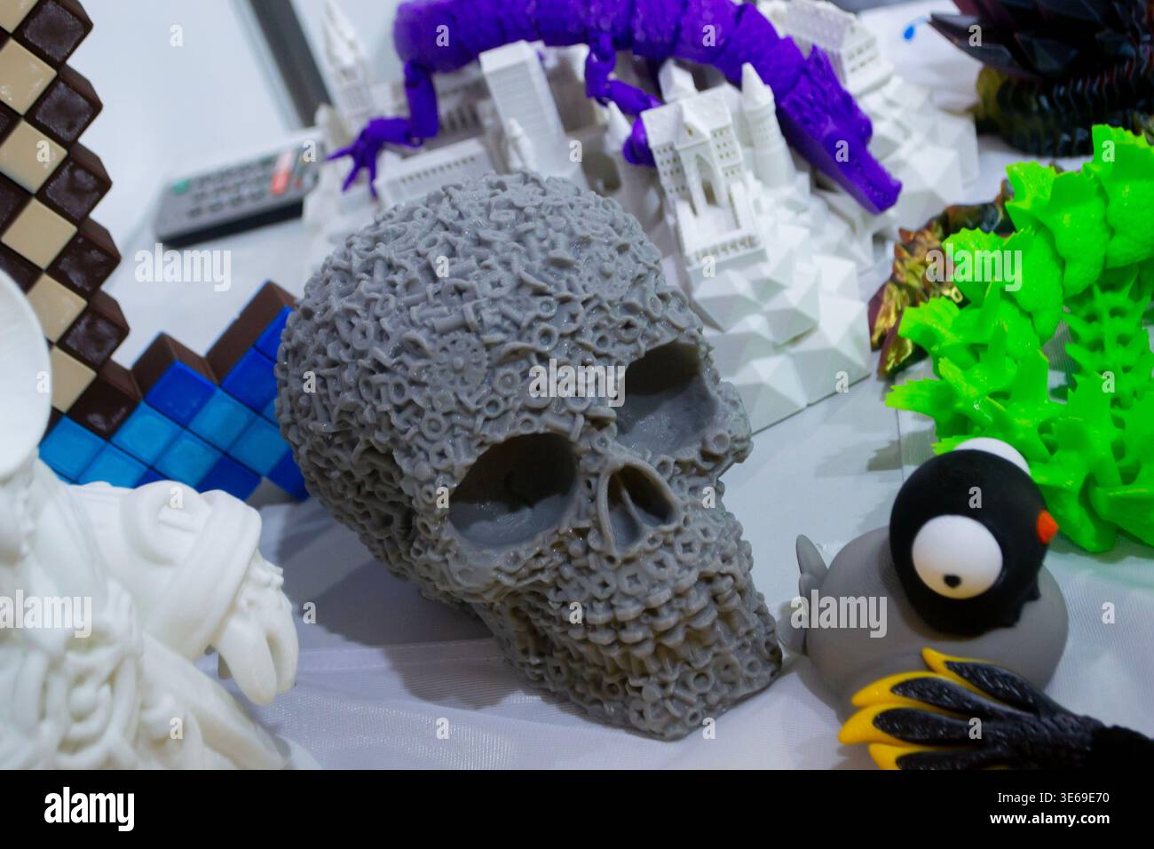 3D printed different art objects. Objects printed on 3D printer from melted colored plastic. Model gray skull created on 3D printer from threads of molten plastic. Modern new additive technologies Stock Photo