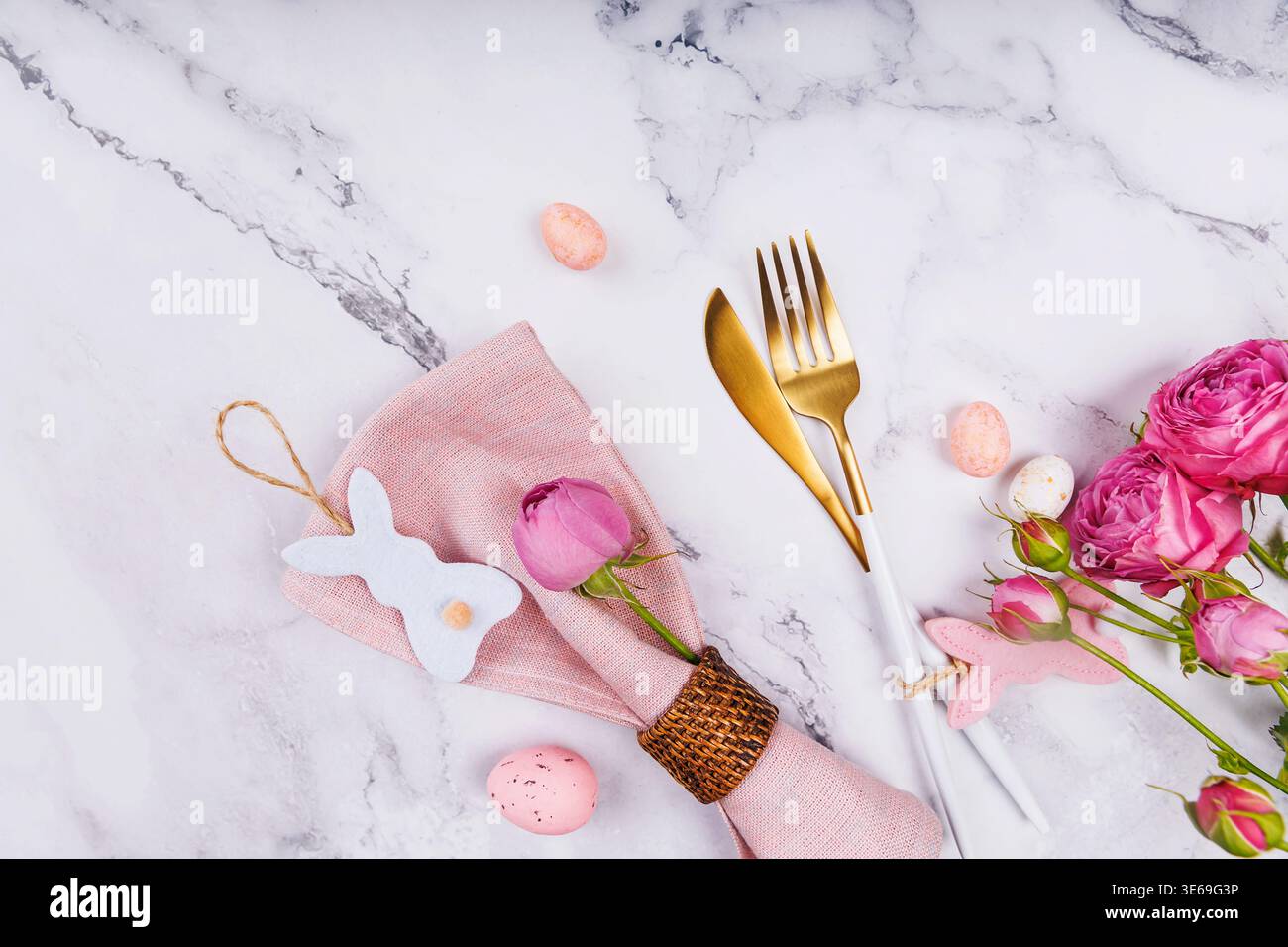 Easter Table Decor with Blue Napkin and Pink Bunny Stock Photo