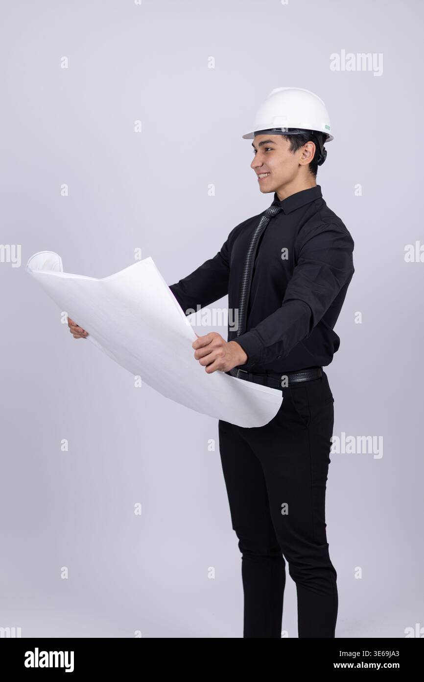 Engineer in white helmet looking at a blueprint Stock Photo