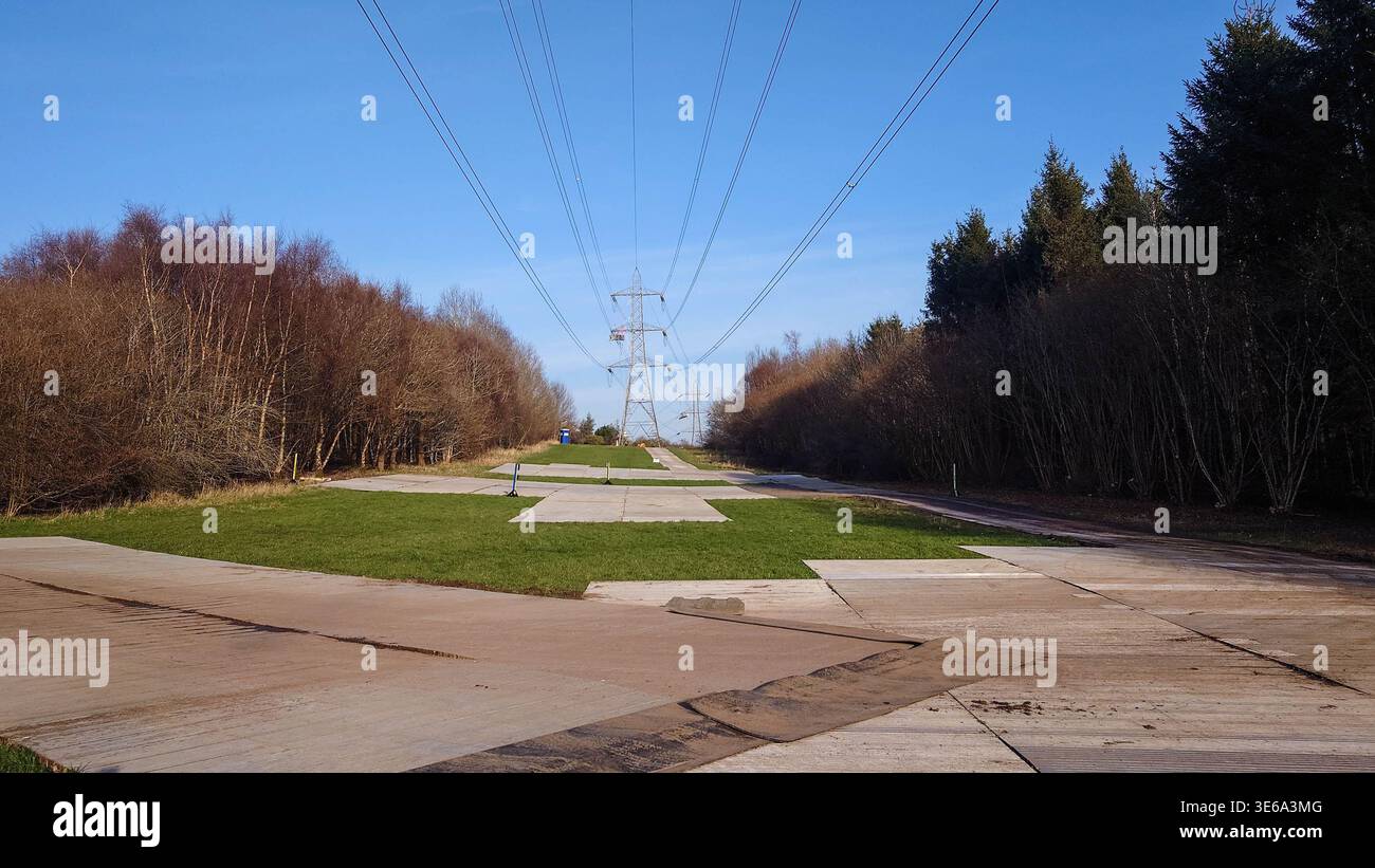 Conductive protective mats under high voltage electricity cables between transmission towers creating an equipotential safe work zone for maintenance Stock Photo