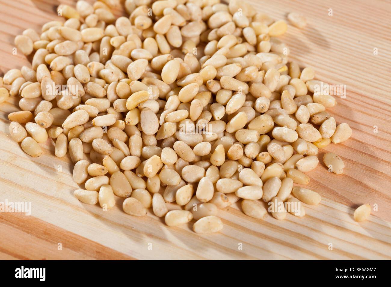 Photo of mix raw pine nut on the wooden desk Stock Photo