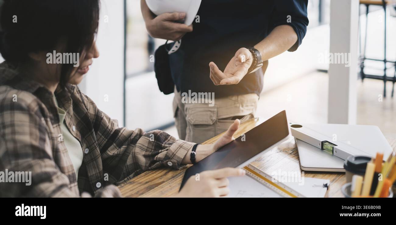 Engineer or architect doing model 3D the project on tablet with partner in offlice. Construction concept Stock Photo