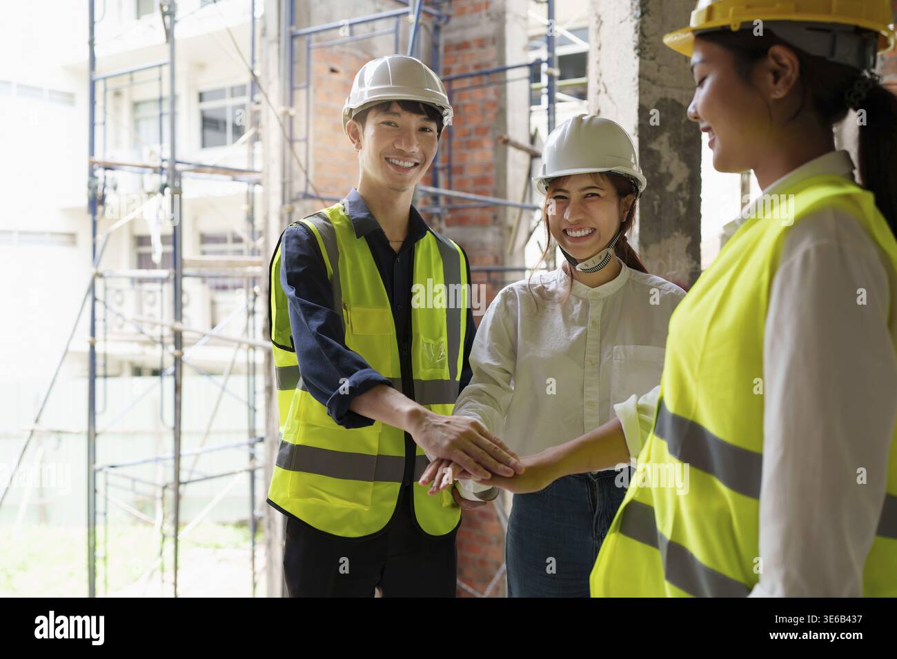 Structural engineer and architect discussing and working with blueprints at the outdoors construction site Stock Photo