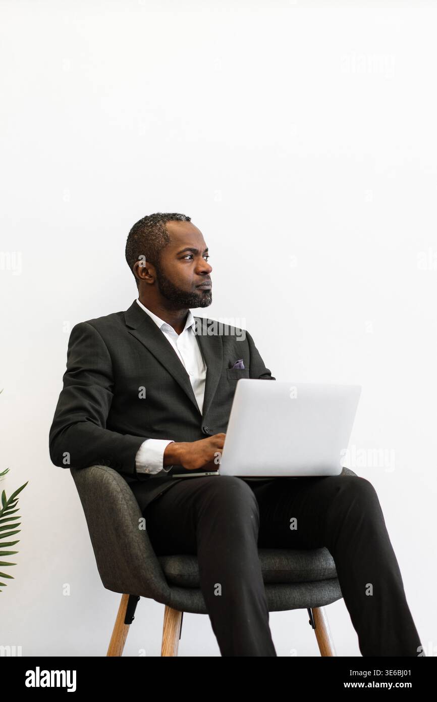 Man in Suit With Laptop Stock Photo