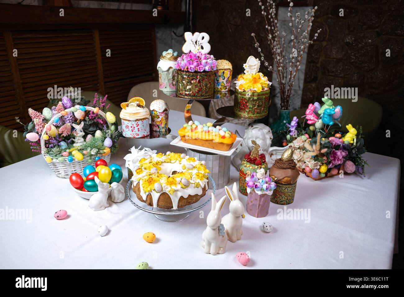Festive Easter Table with Decorated Kulichi, Bunny Figurines and Colored Eggs Stock Photo