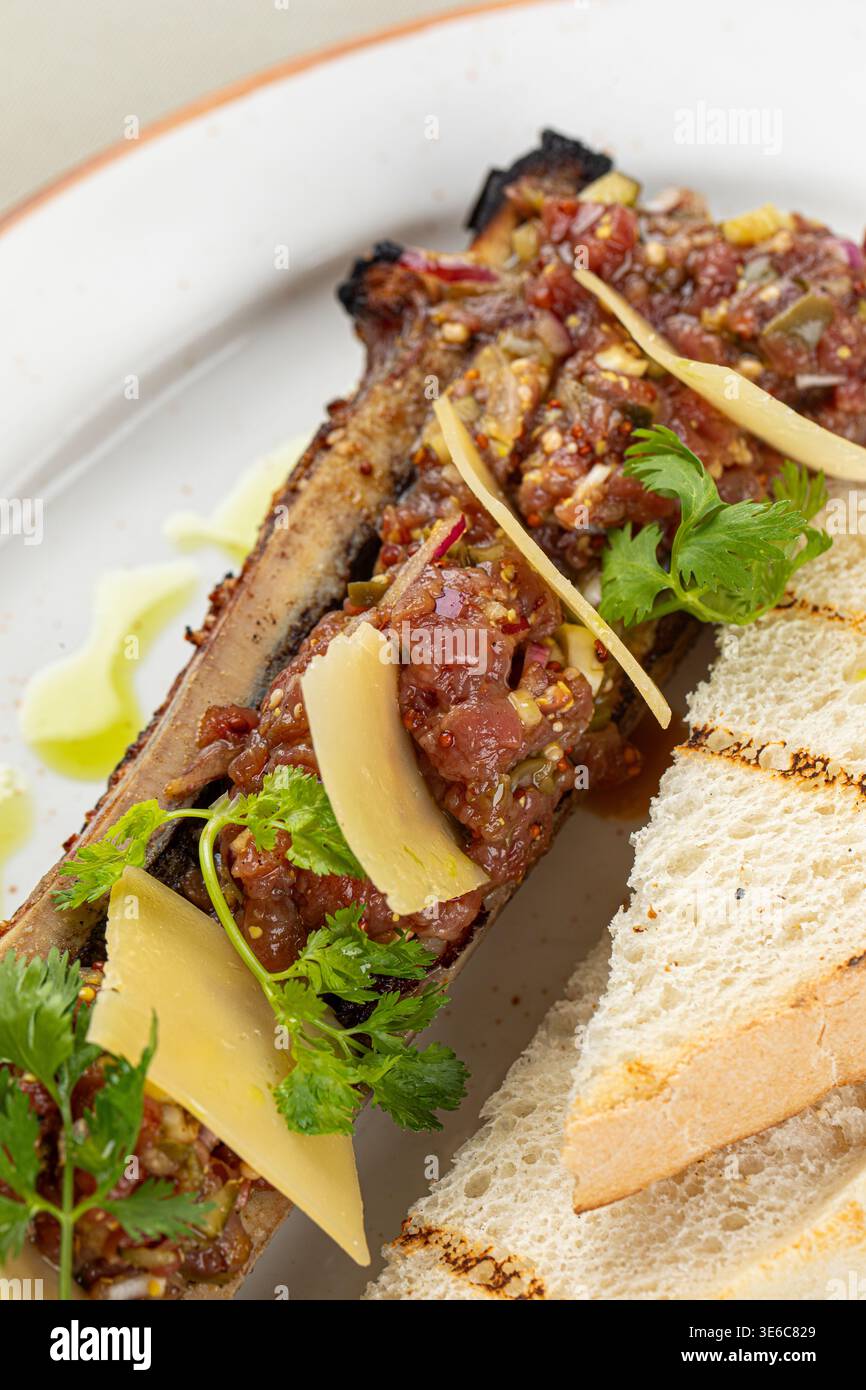 Bone marrow with beef tartare and bread slices Stock Photo