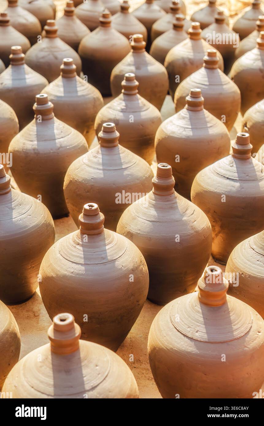 Unglazed earthenware pots with rounded bodies and narrow openings ...