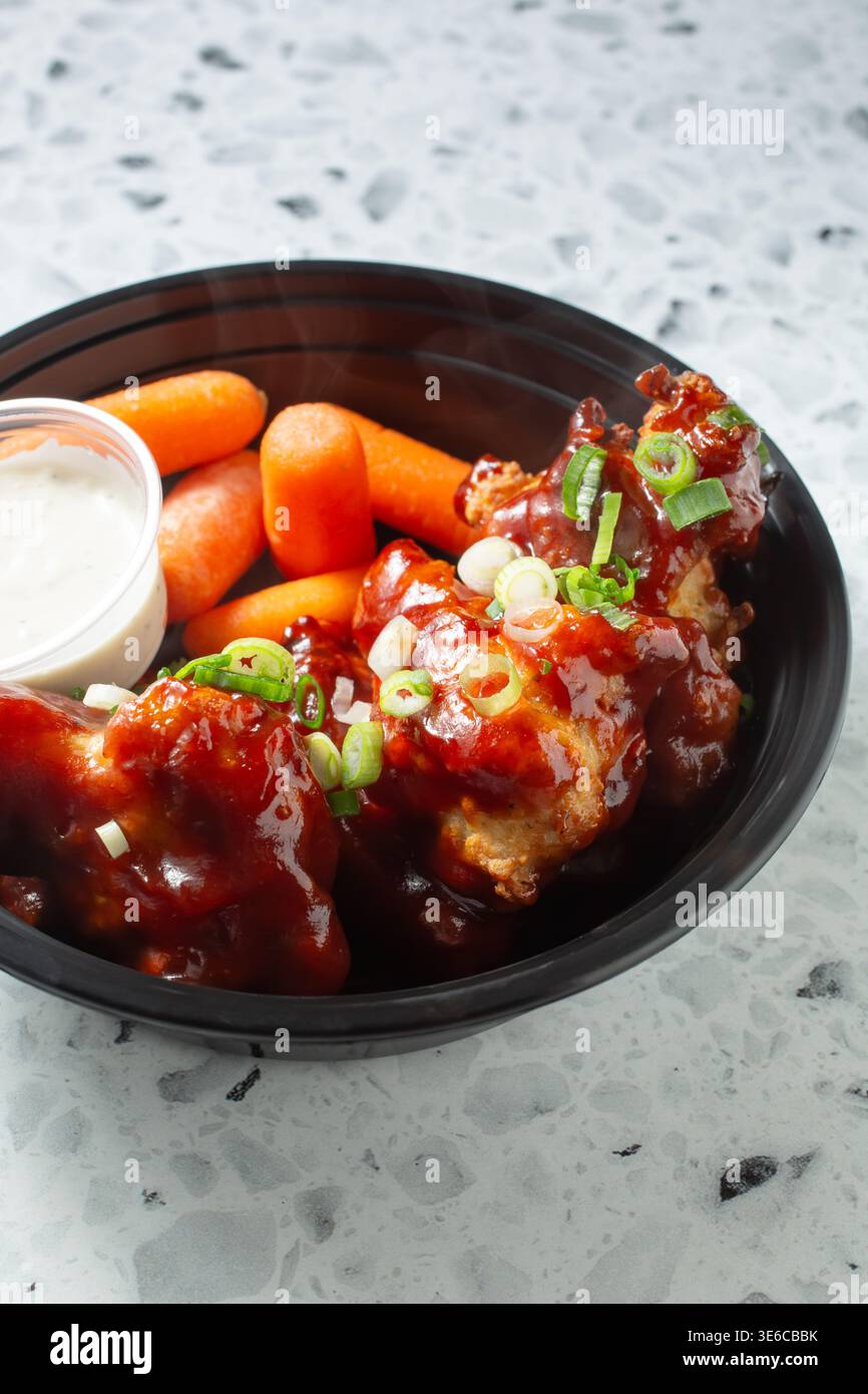 A view of a bowl of BBQ chicken wings. Stock Photo