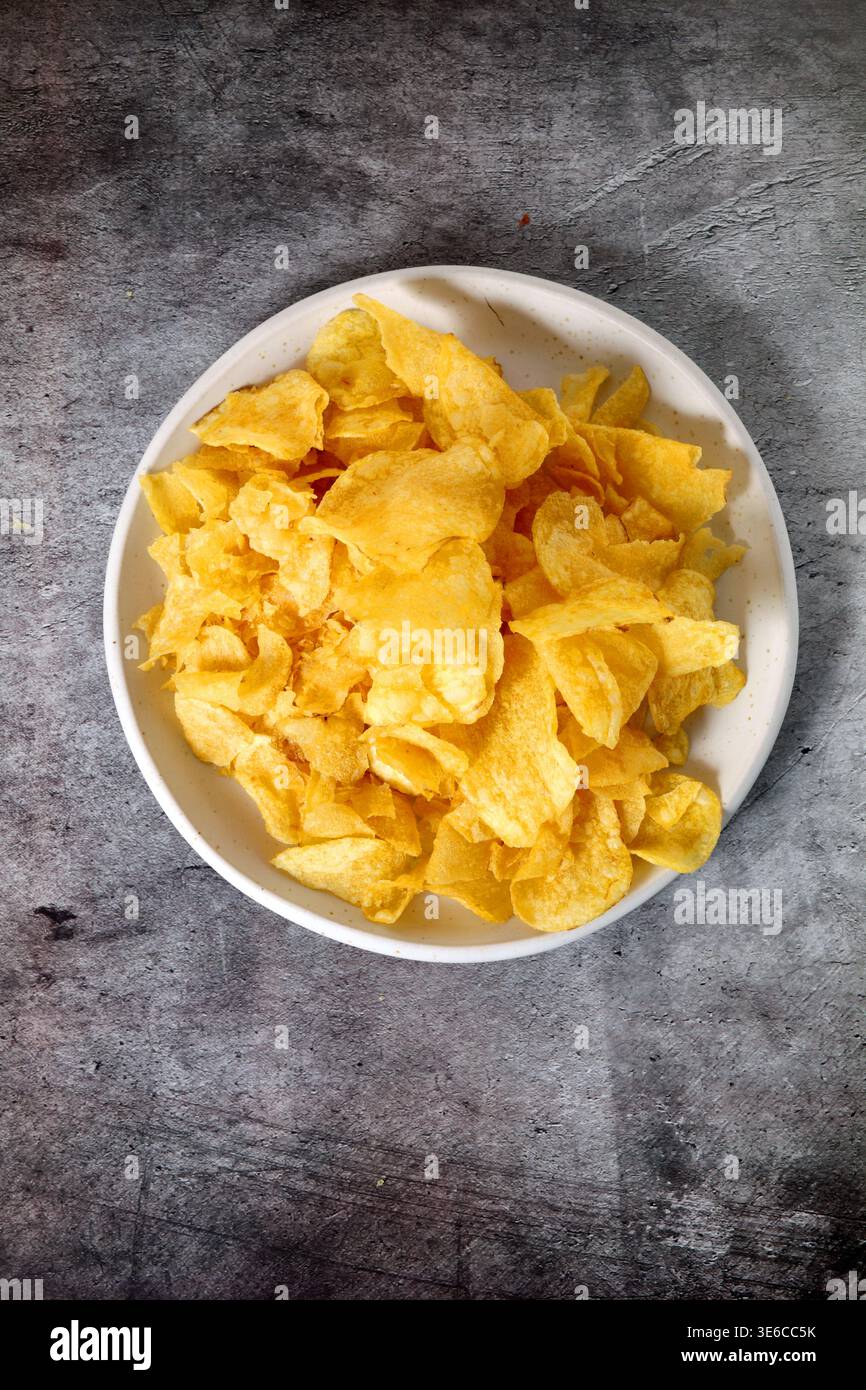 Plate with potato chips seen from above Stock Photo